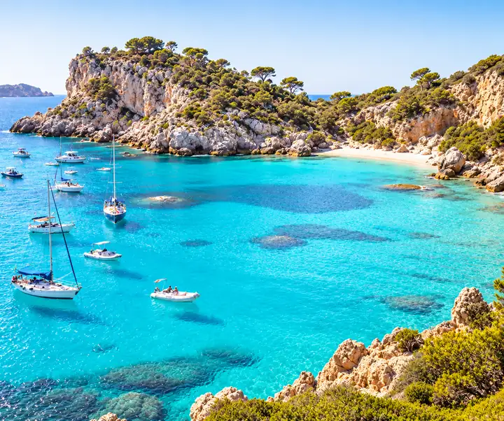Bright turquoise bay with boats scattered across the water